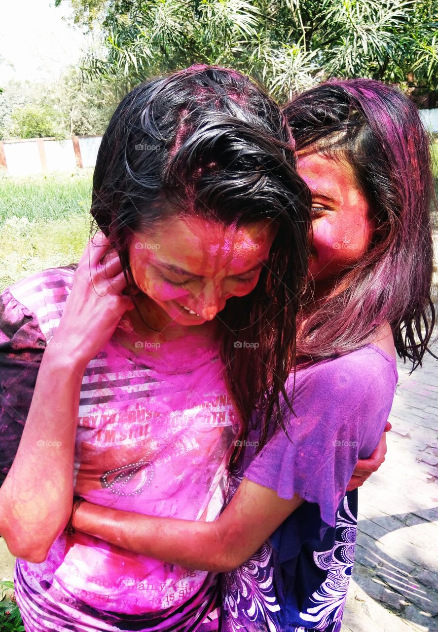 girls playing holi with colors