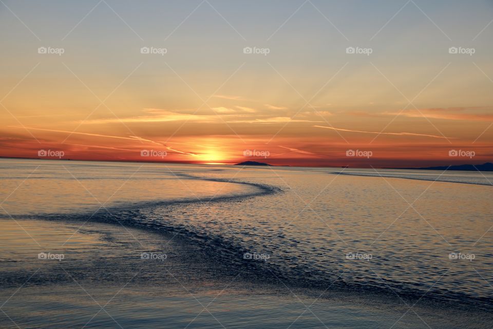 Lucky to capture this sunset on a ferry ride where Fraiser River enters the Pacific , making serpentine of different shades of blue