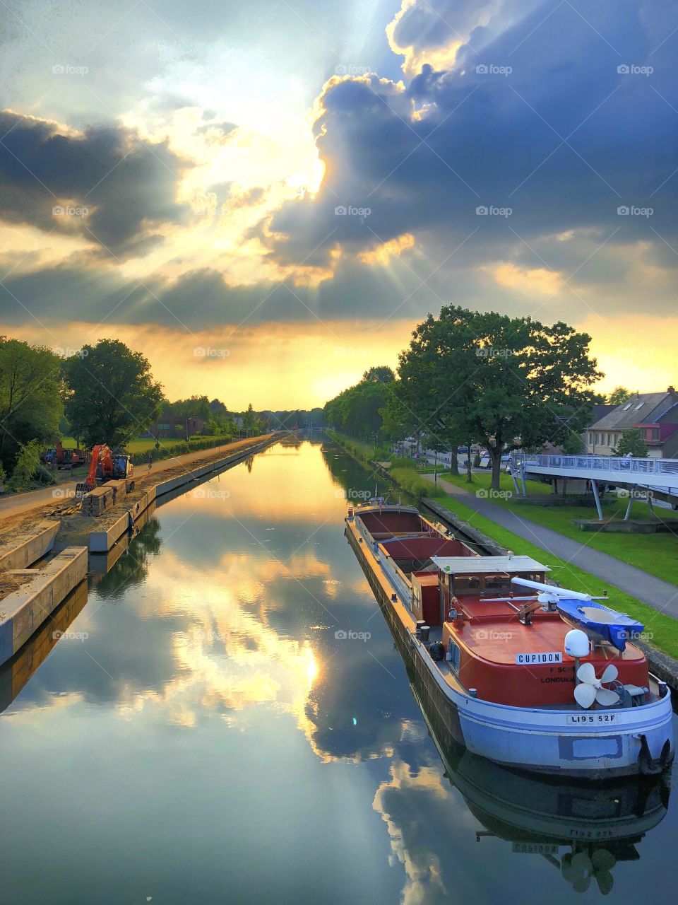 Sunset and a boat on a water road