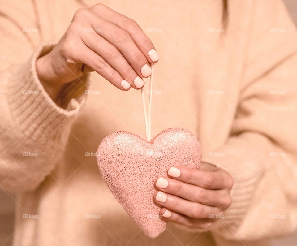 person holding heart toy