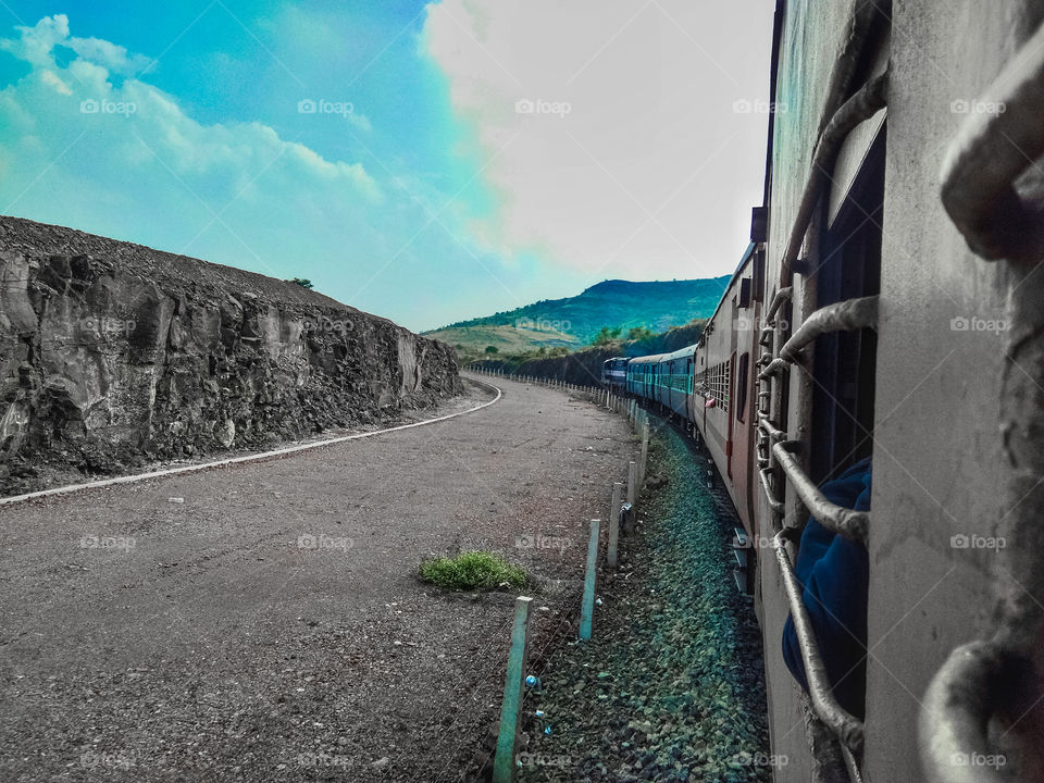 Train ongoing on track from beautiful surrounding.