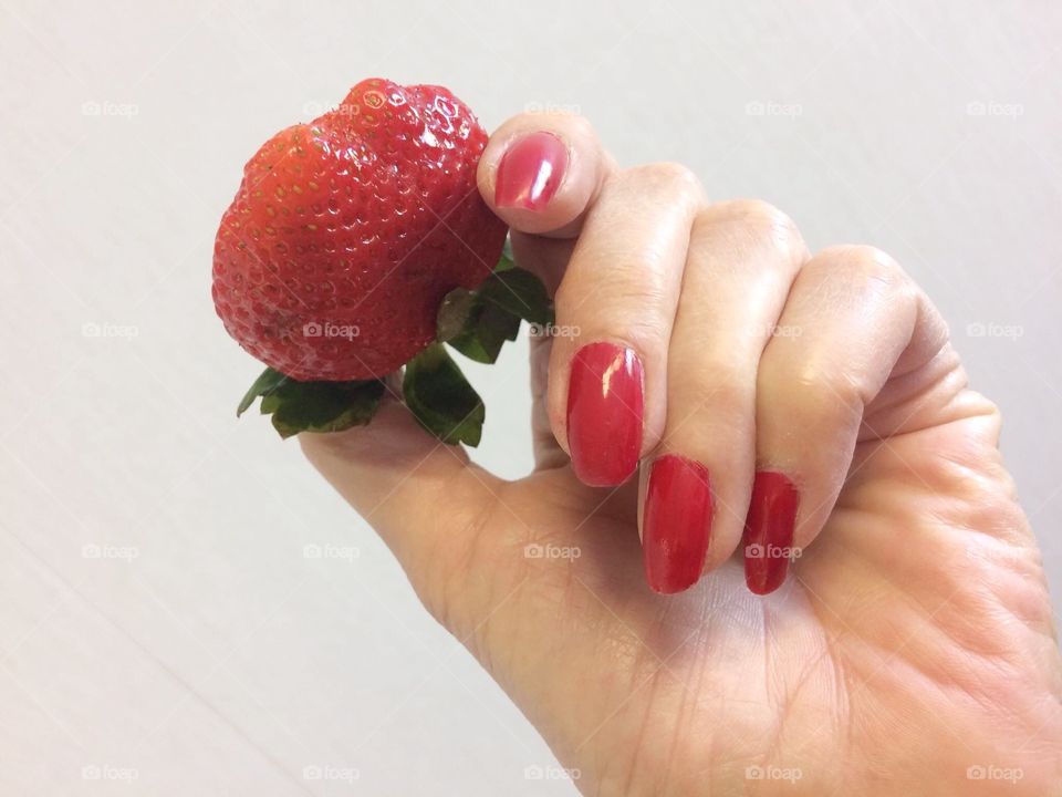 Woman's hands holding a strawberry