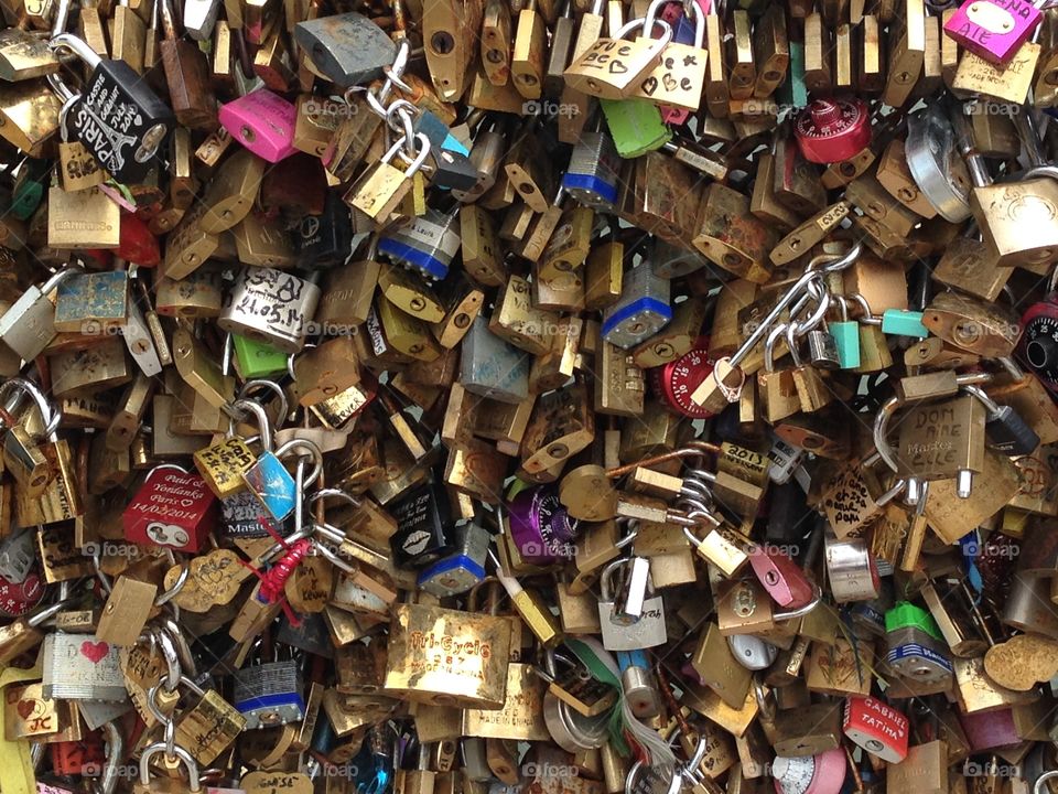 Locks symbolizing love attached to a bridge over the Seine in Paris, France. 