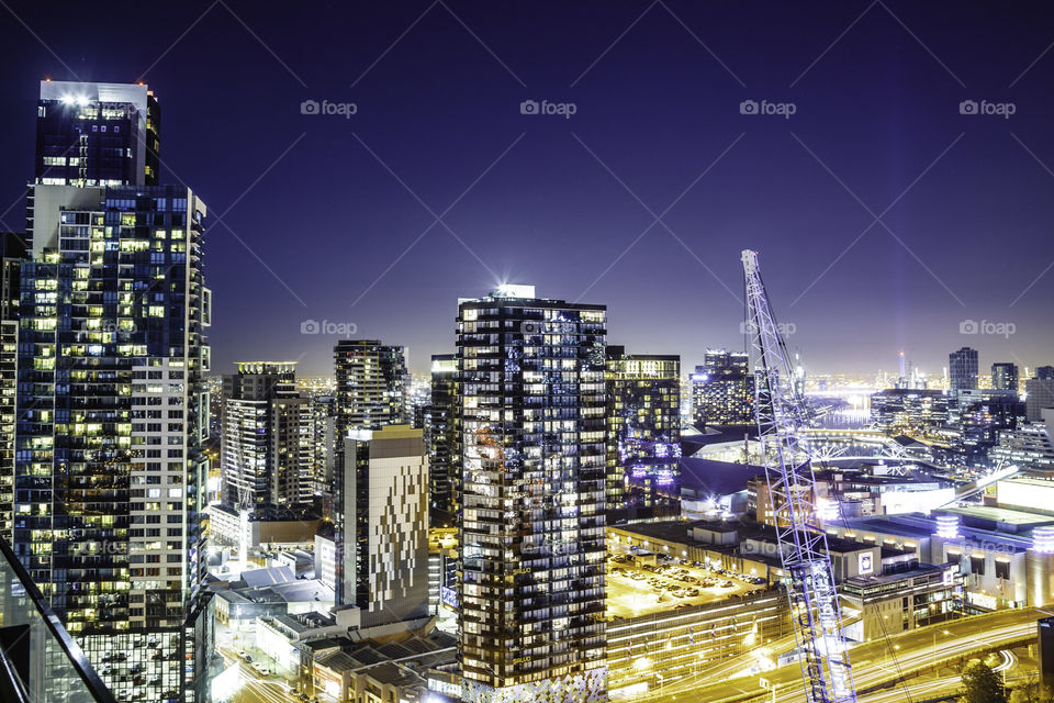 Illuminated cityscape against sky at night