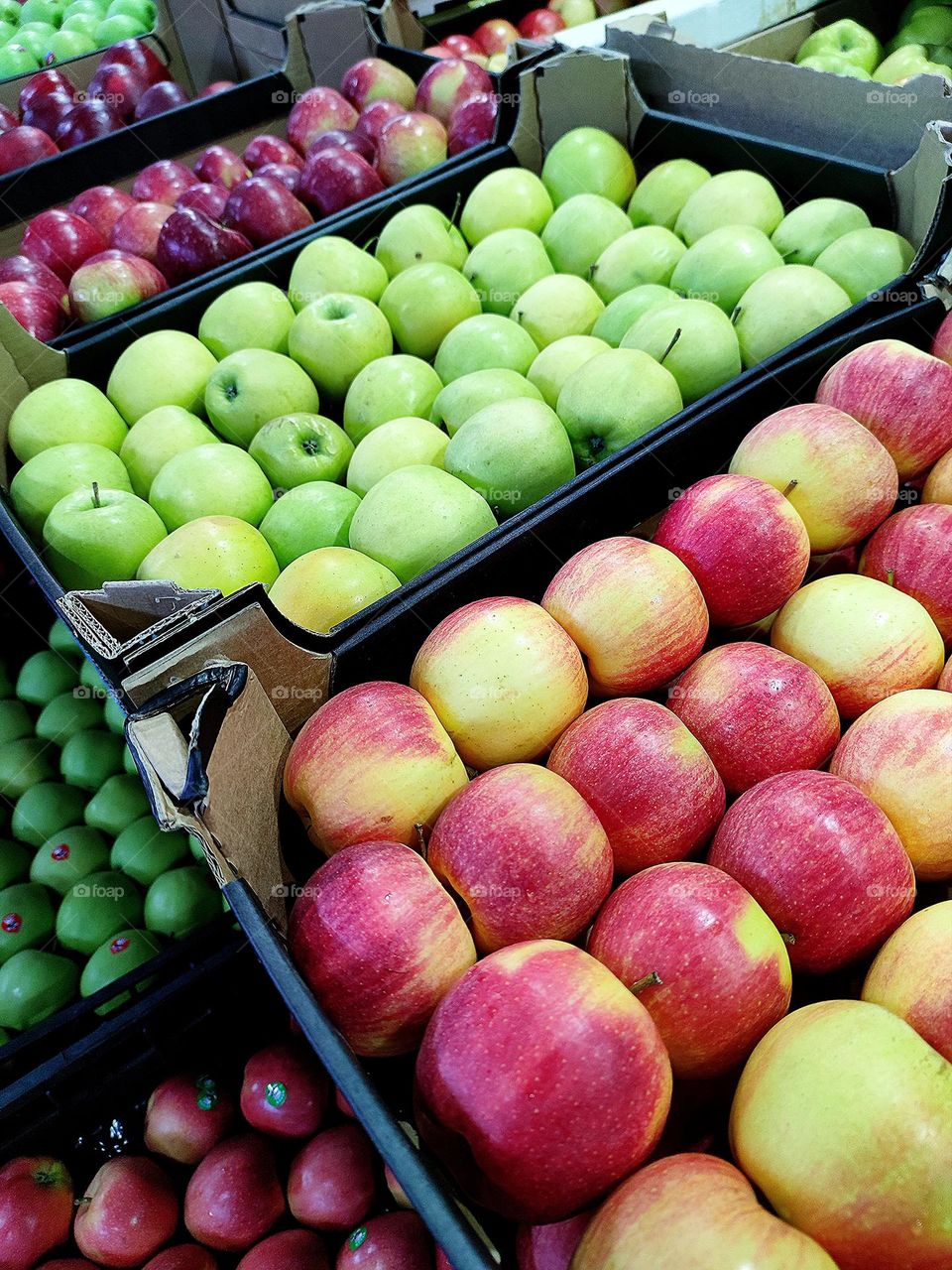 Market.  Boxes with apples of different varieties and colors