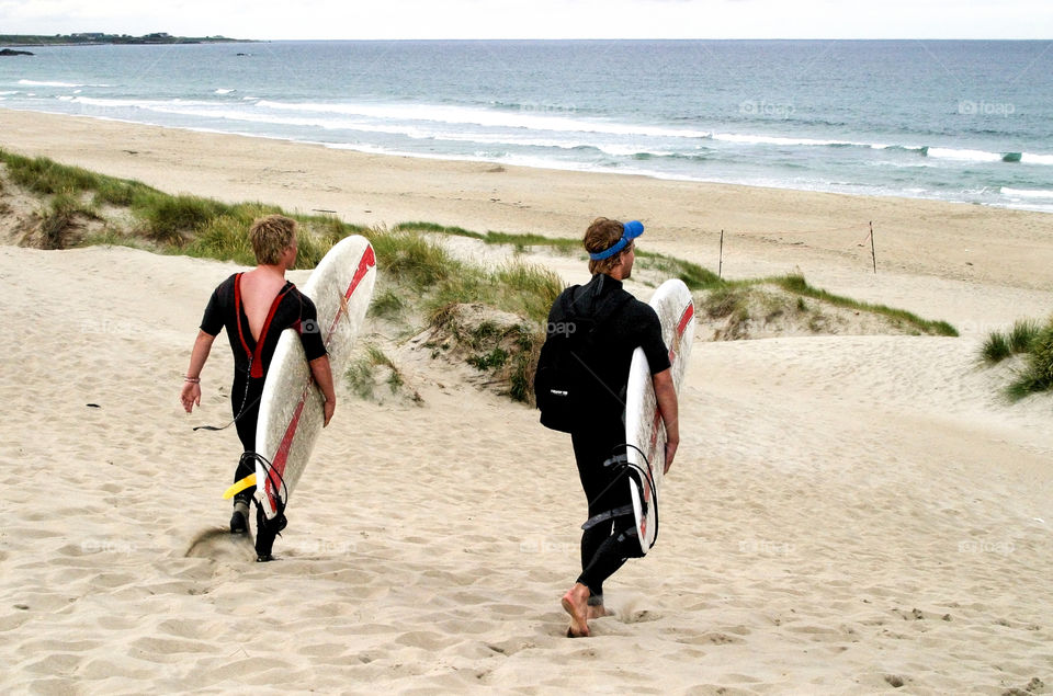 Boys go surfing. 