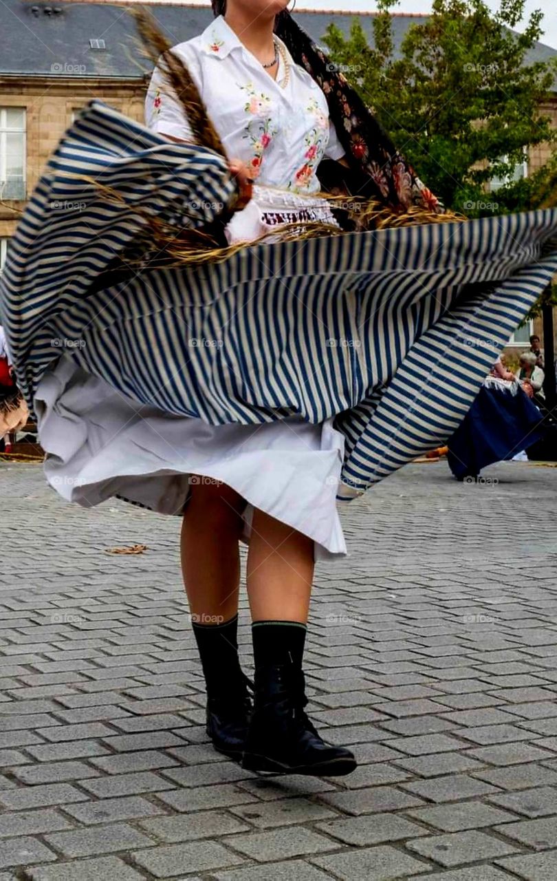 The twirling skirts of a woman dancer of the group Quic en Grougne's show in Saint-Malo