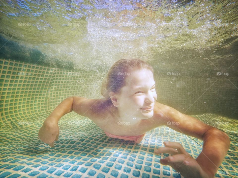 Little mermaid in the swimming pool