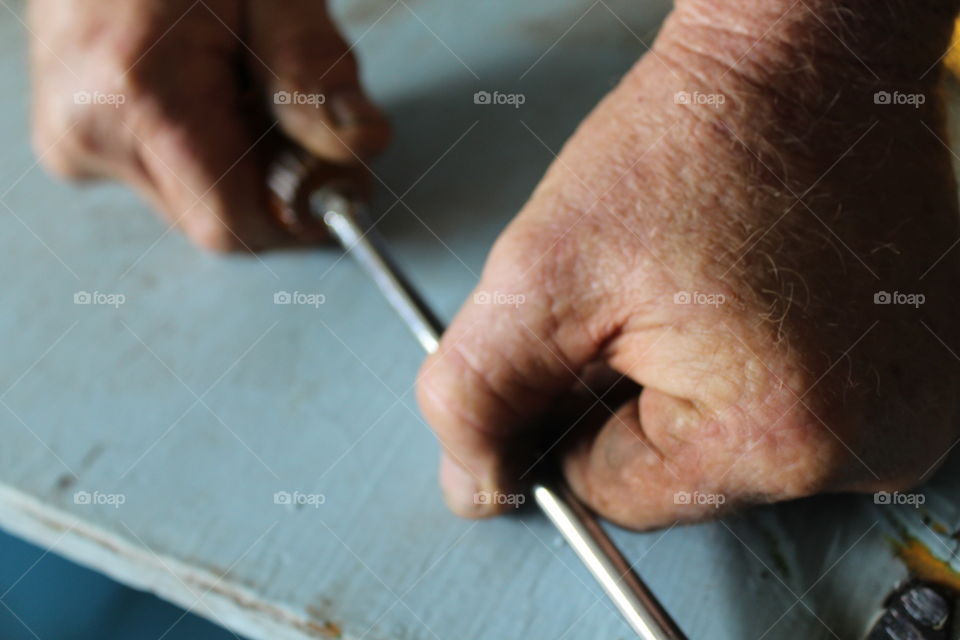 close-up of carpenter holding screwdriver