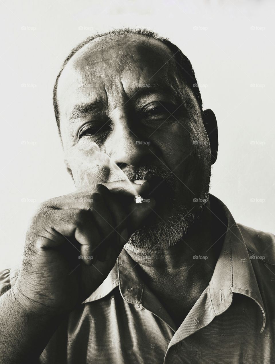 Black and white image of a smoking man