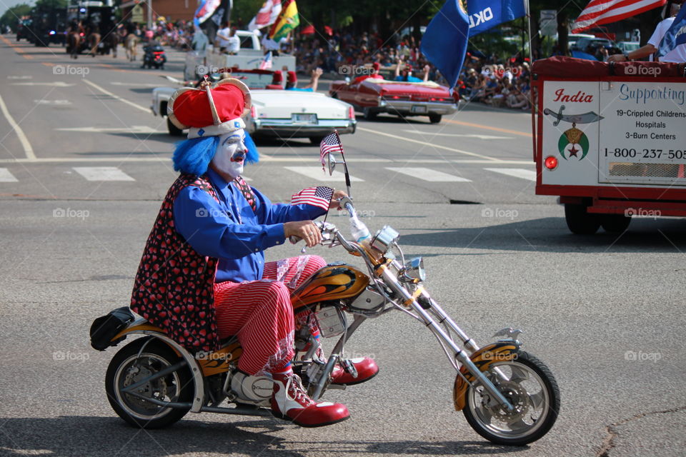 Clown on a Motorcycle with Flag