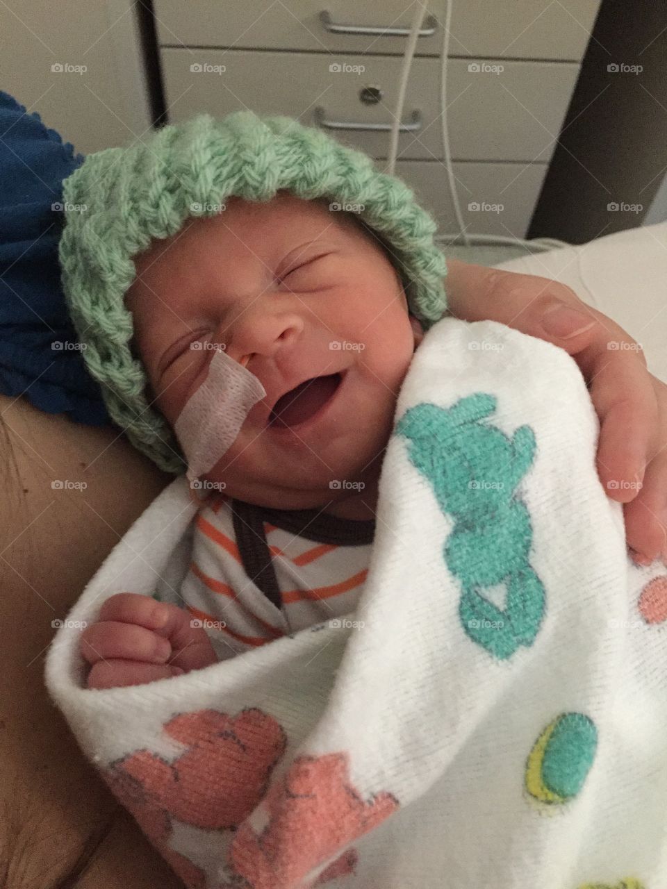 Two week old premature baby boy on mother’s chest 