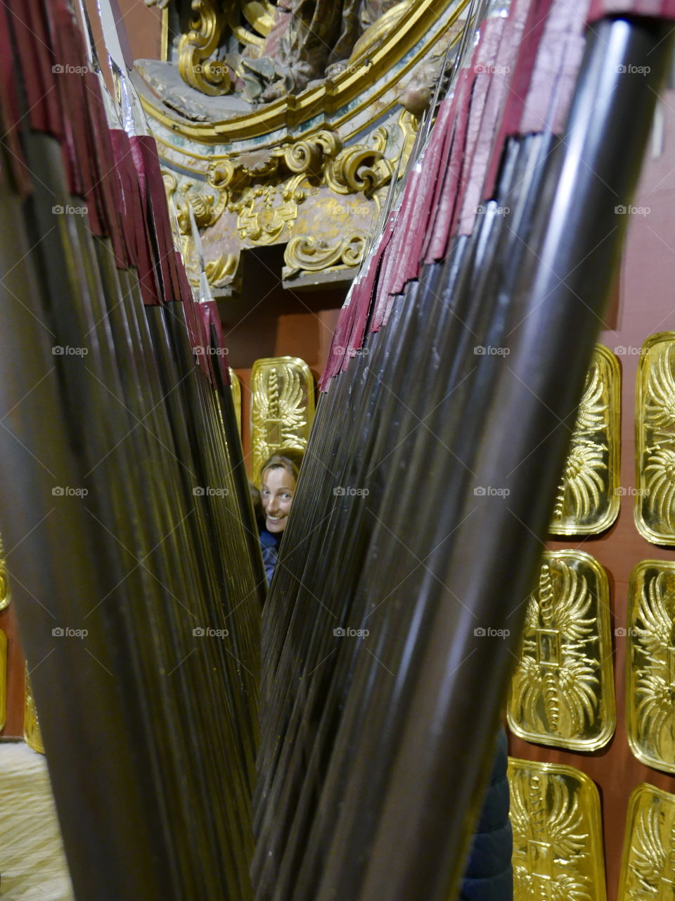 Smiling woman and weapon in museum