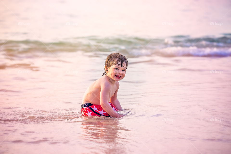 Boy sitting on body board