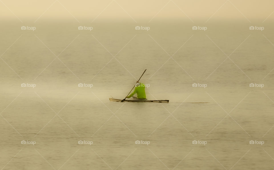 Solo kayaking in misty morning.