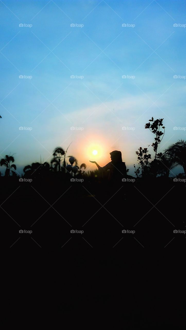 sunset in the hands of the girl