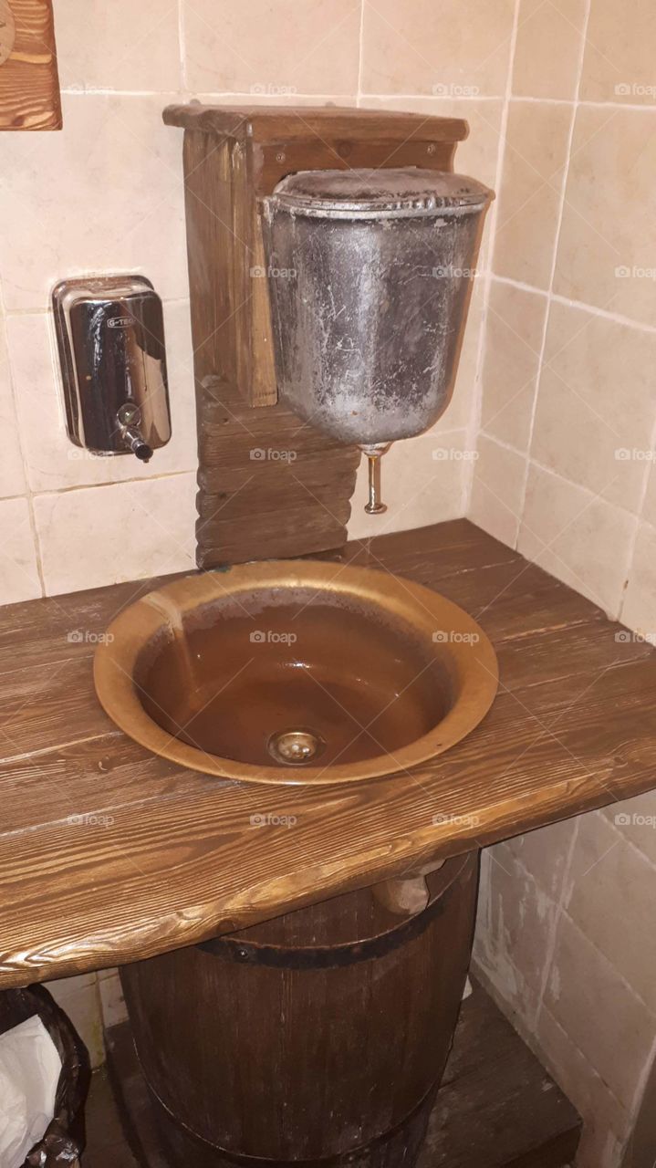 In the toilet of the cafe sink washstand in a wooden design