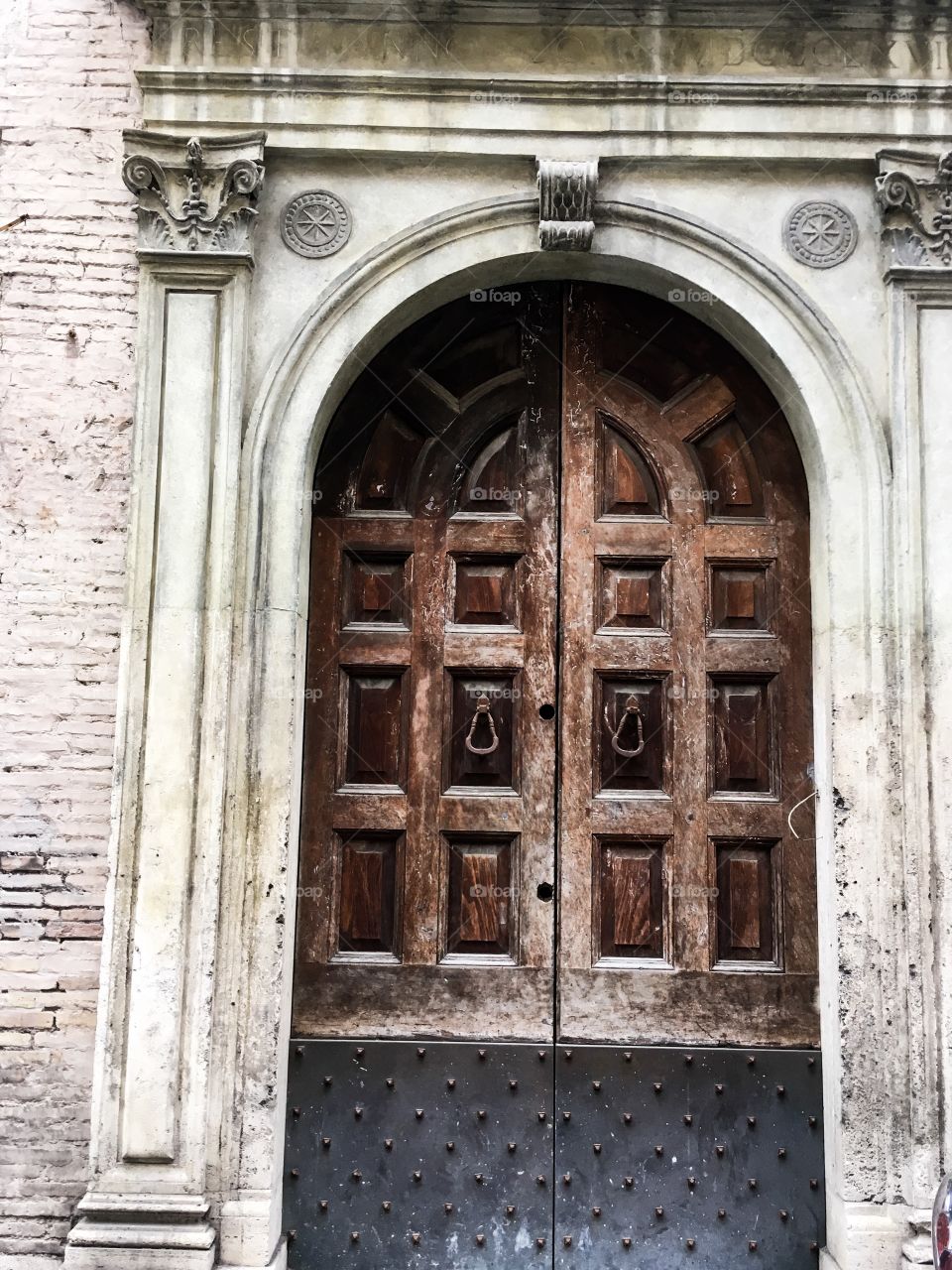 The very old, antique wooden door. Entrance background. At the one of Rome street. 