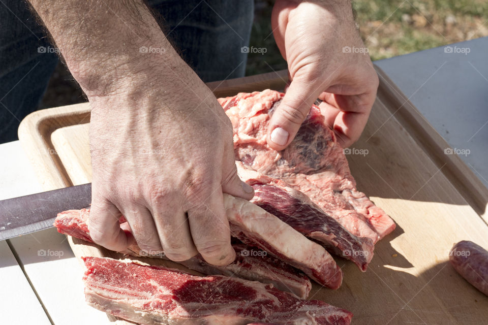 Close-up of man's hand preparing lamb meat