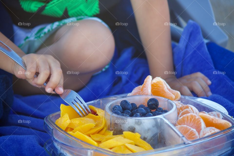 Eating an assortment of fruit