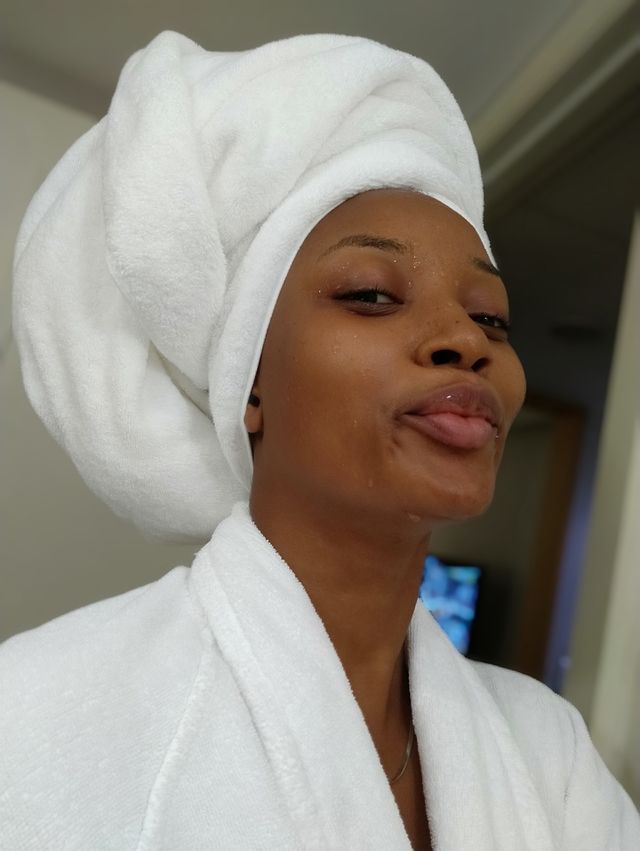Happy lady wearing a white bath robe and towel