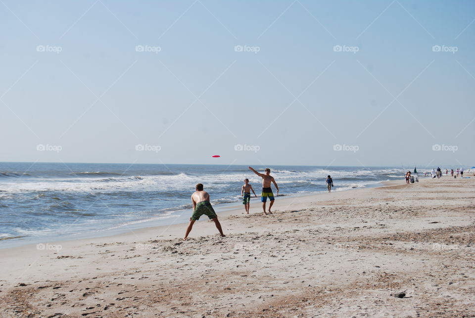 Playing Frisbee at the beach. Playing Frisbee on the beach