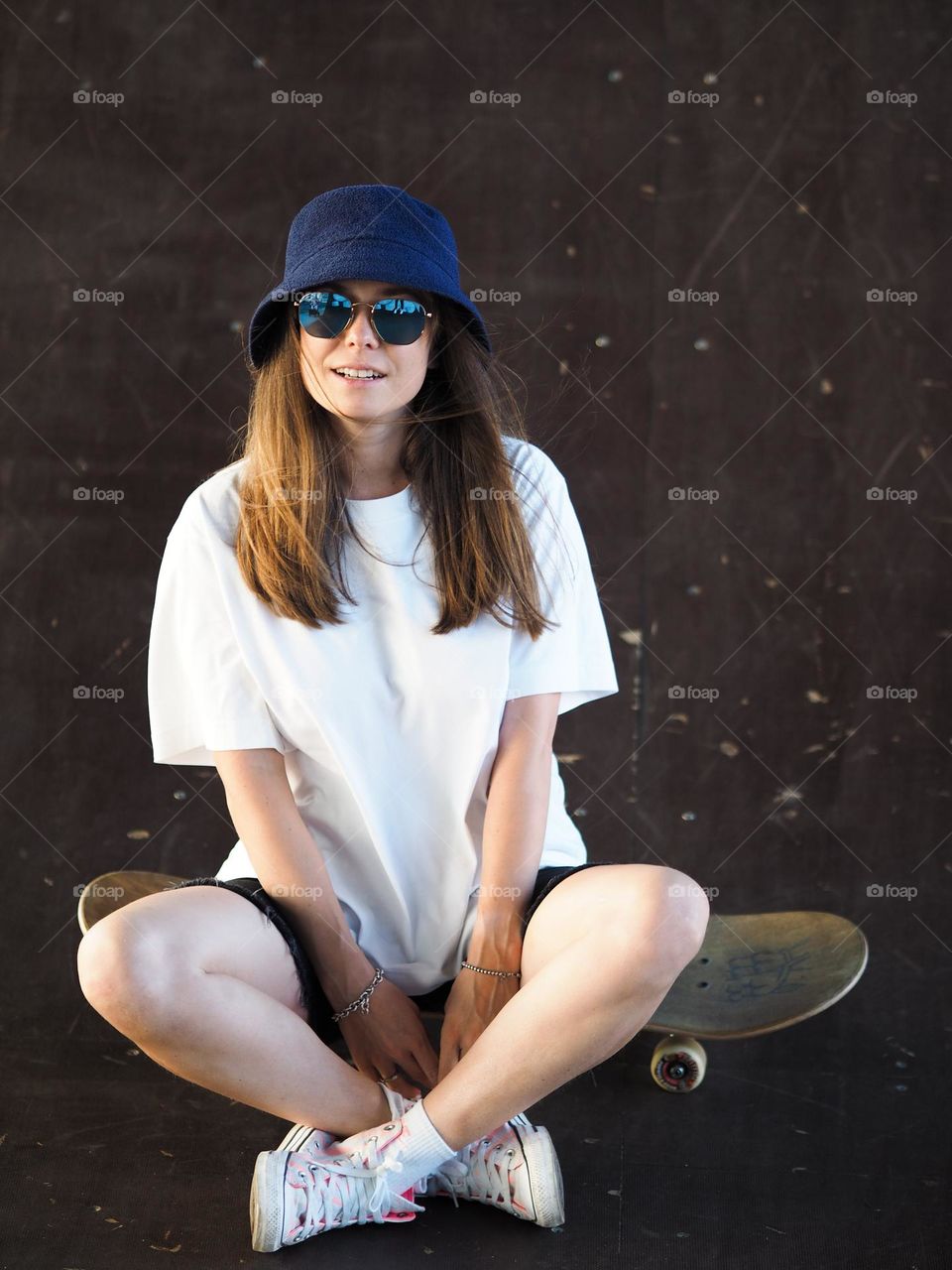 Young beautiful girl with skateboard 