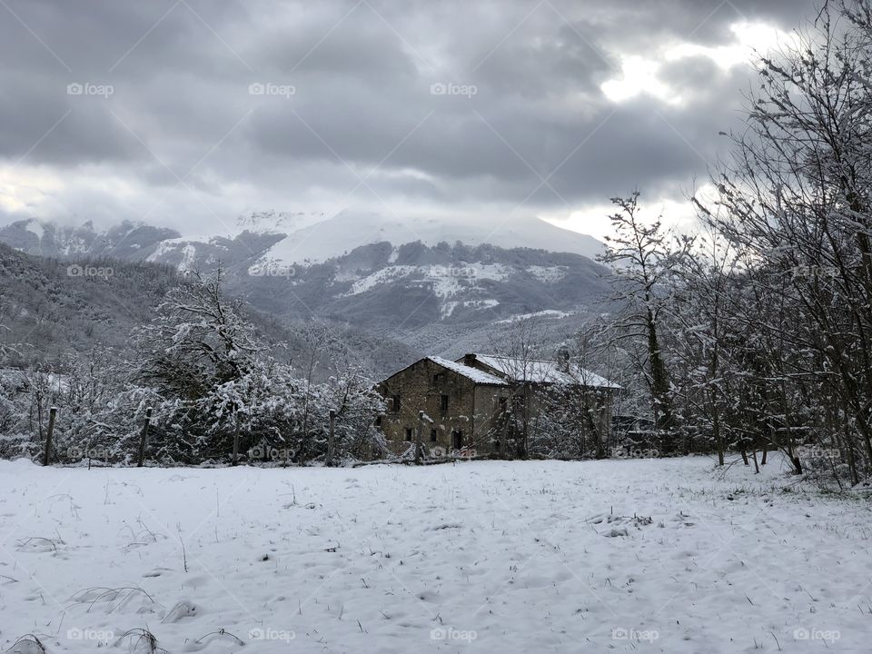 Snowy landscape with abandoned house