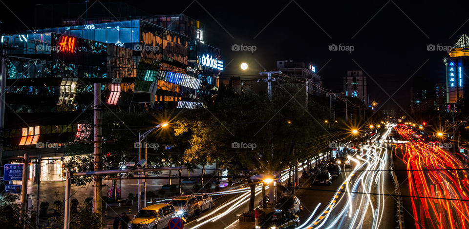 Asia, China. Beijing. traffic .rush hour. full moon light strips Sanlitun