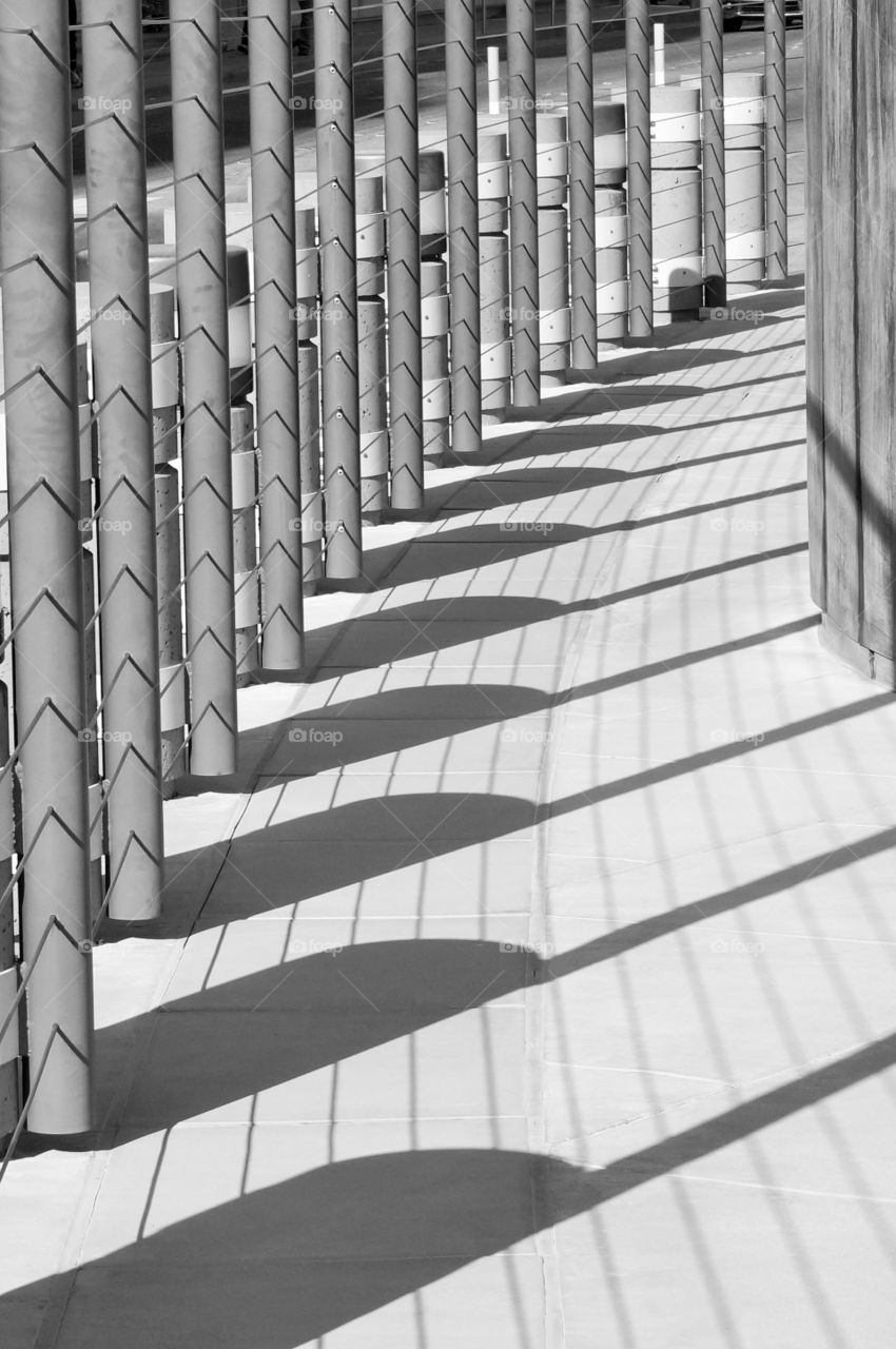 Fence casts shadow pattern. Brick path, fence and shadow pattern.  Photo taken at Hoover Dam.