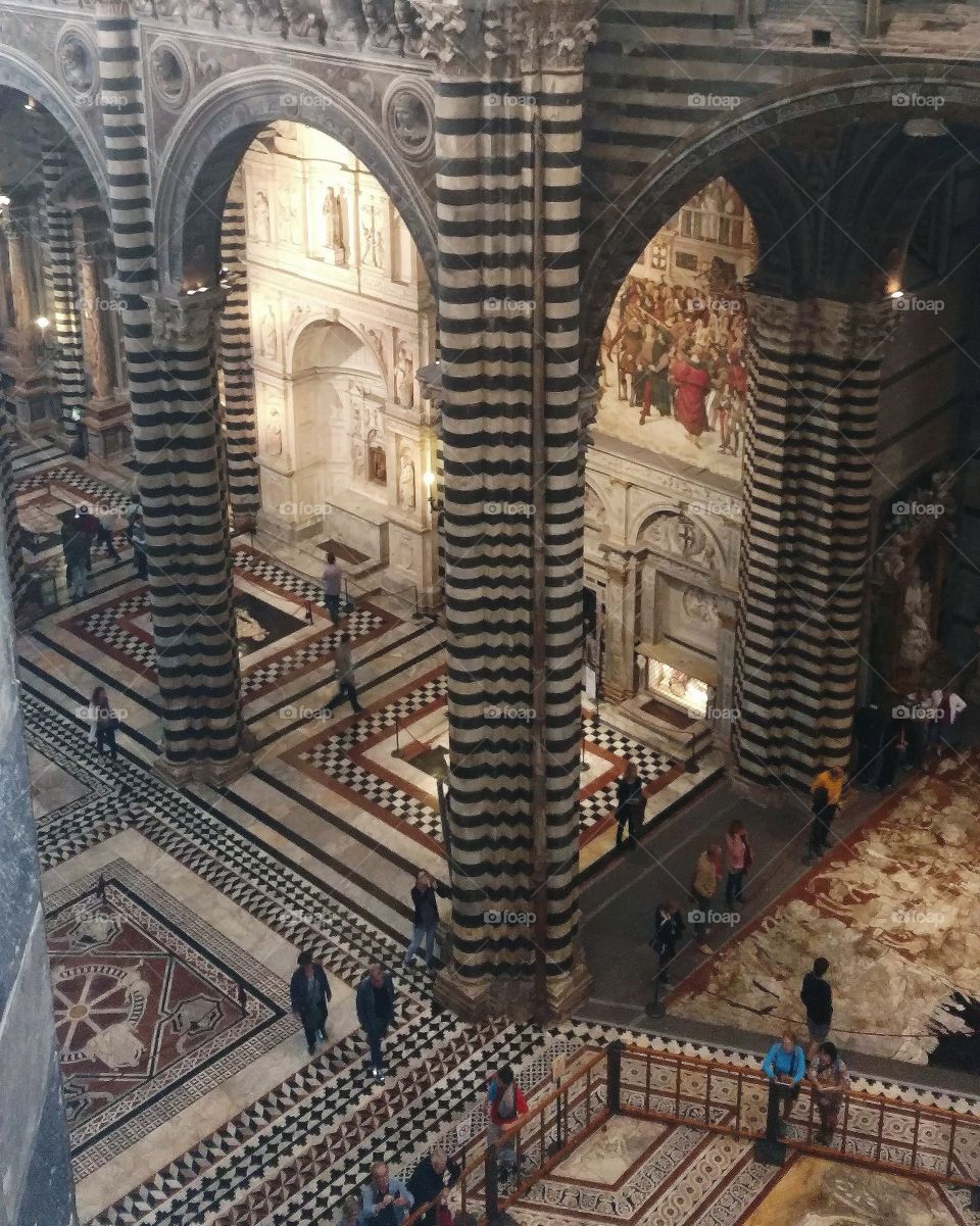 The Duomo of Siena, aerial view.  The cathedral's beautiful mosaic floor, which is often covered to protect it, is fully on display.