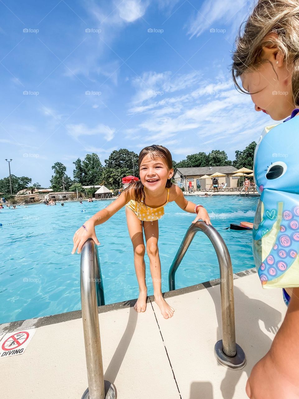 A girl coming out of the pool 