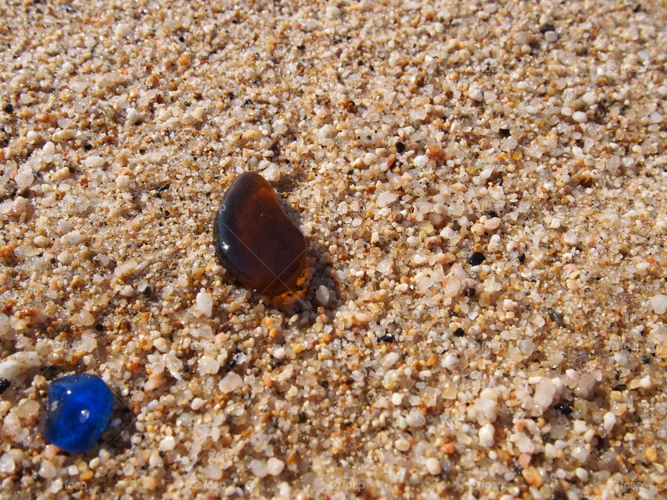 Elevated view of gemstones on sandy beach