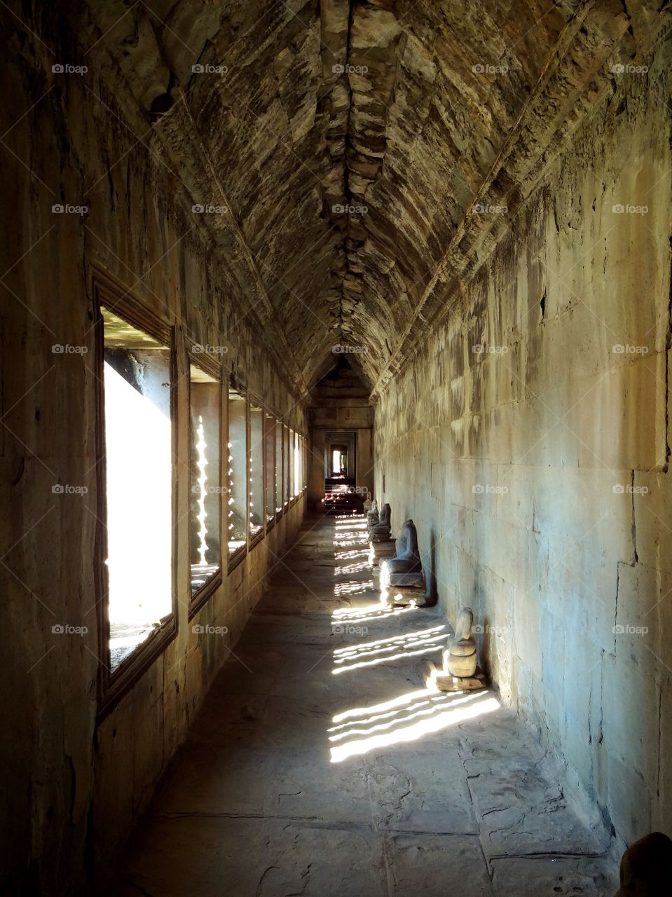 Angkor Wat temple hallway of buddha statues, siem reap cambodia. Color and light in hallway