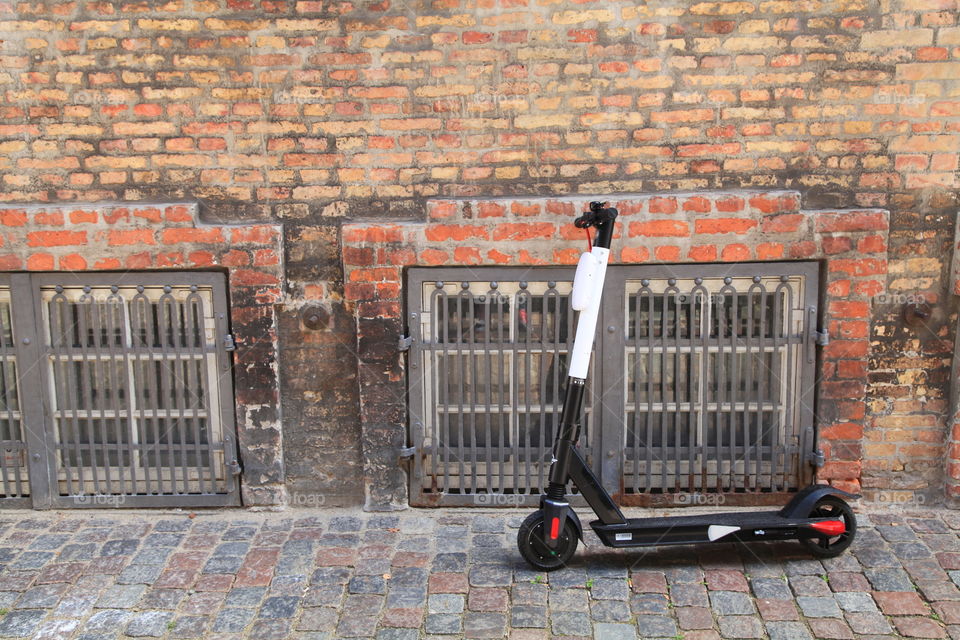 electric scooter on the way A to B in old town