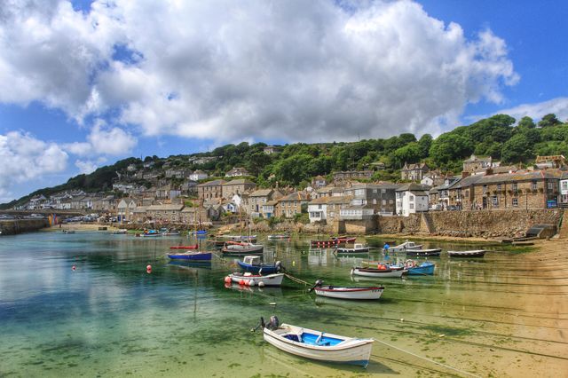 The small Cornish fishing village and harbour of Mousehole in  
Cornwall on a sunny day.