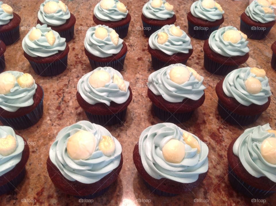 Beautiful beach theme cupcakes chocolate seashells.