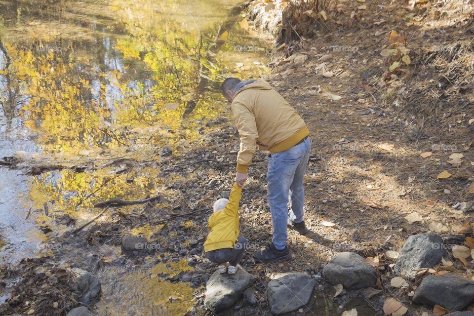 Back view of man and child in park