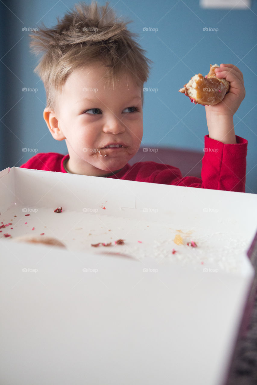 Messy donut eating boy 