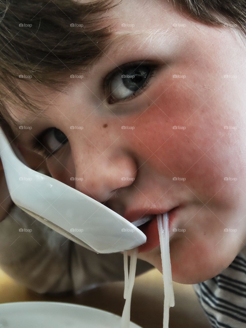 Young Boy Slurping Noodles