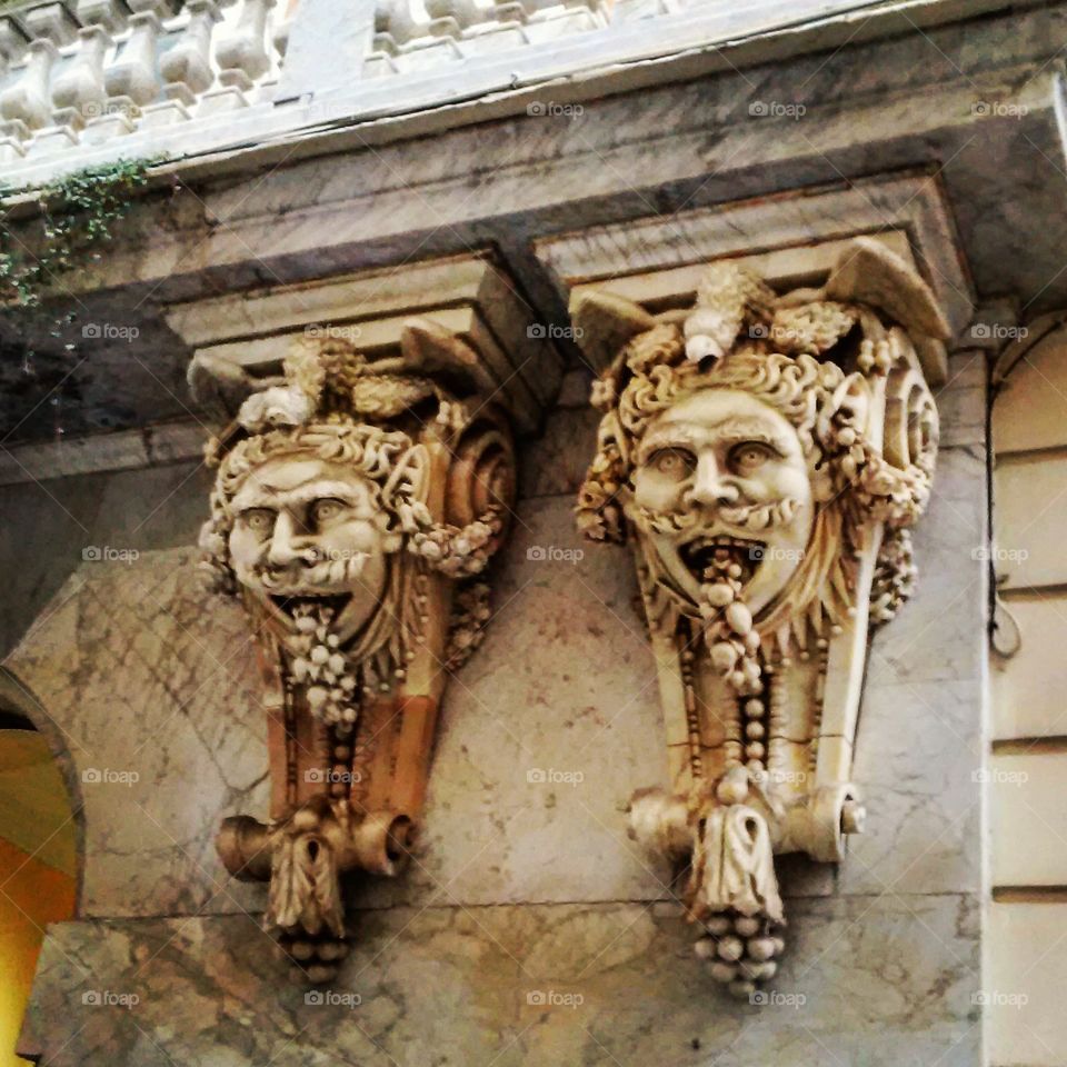 Grotesque yet charming fixtures decorating an old building in Cadiz, Spain.