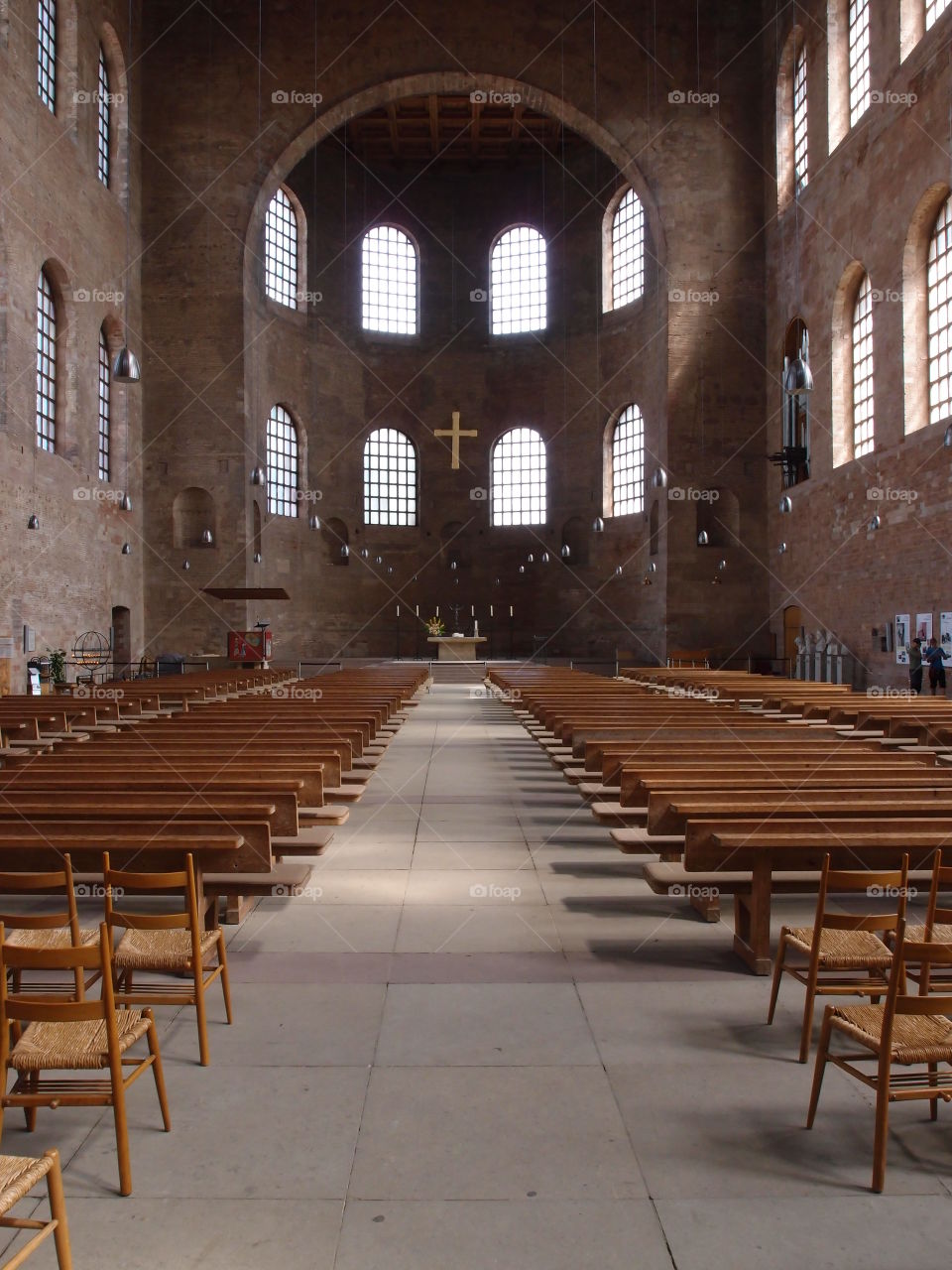 The center isle in an old European church leading through the pews to the alter. 