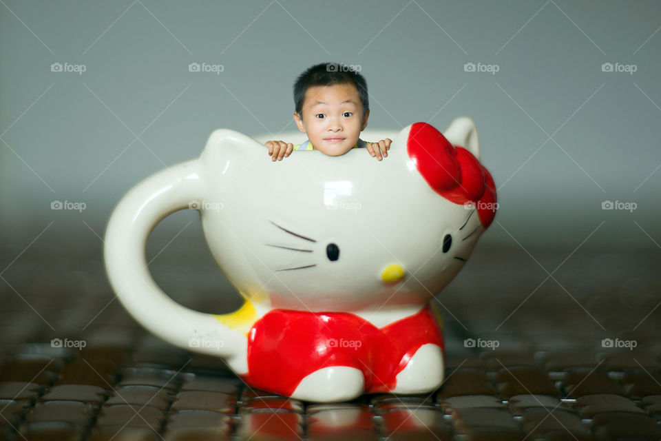 Tiny Boy in A Hello Kitty Cup
