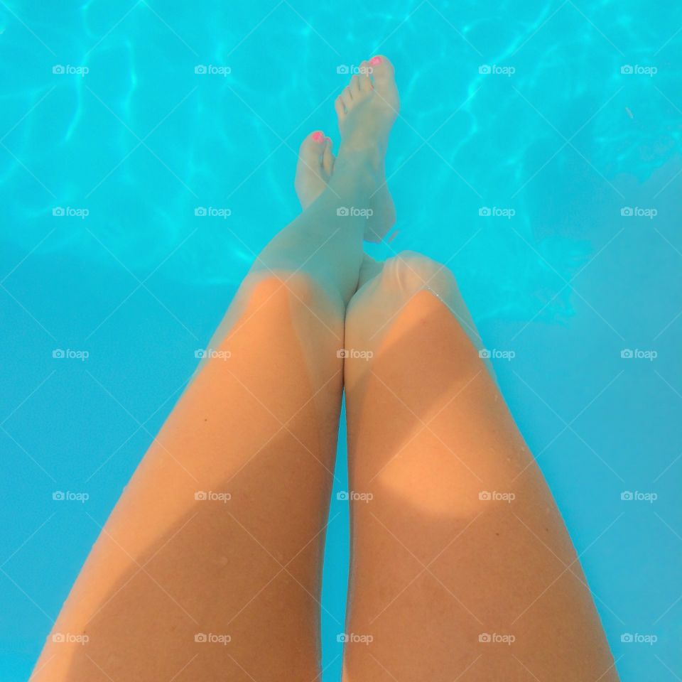 View of women's legs in the pool