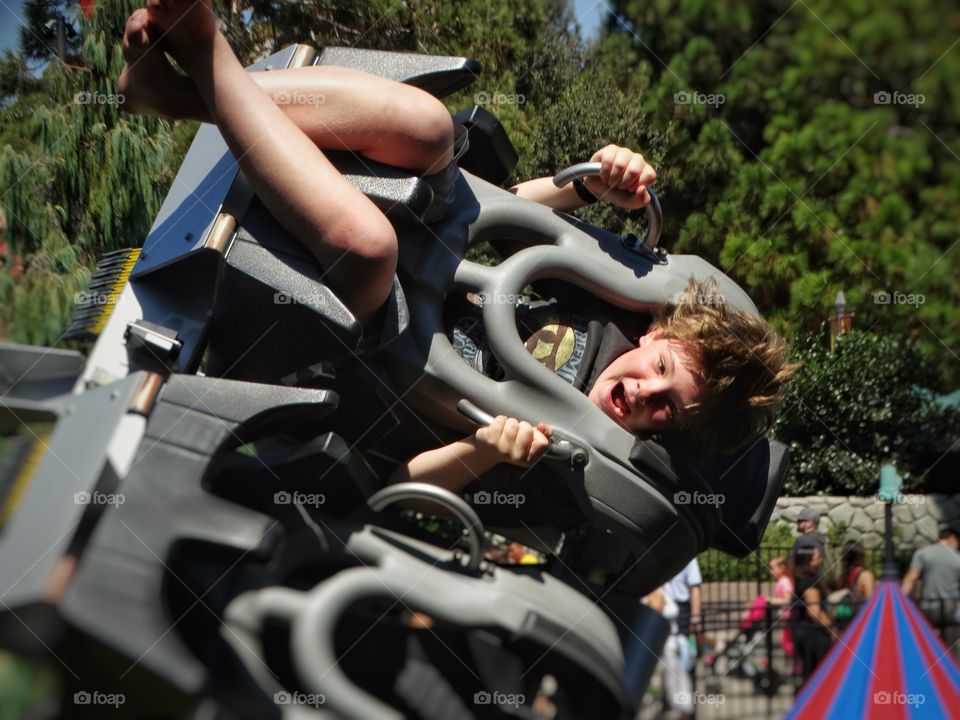 Boy enjoying ride at amusement park