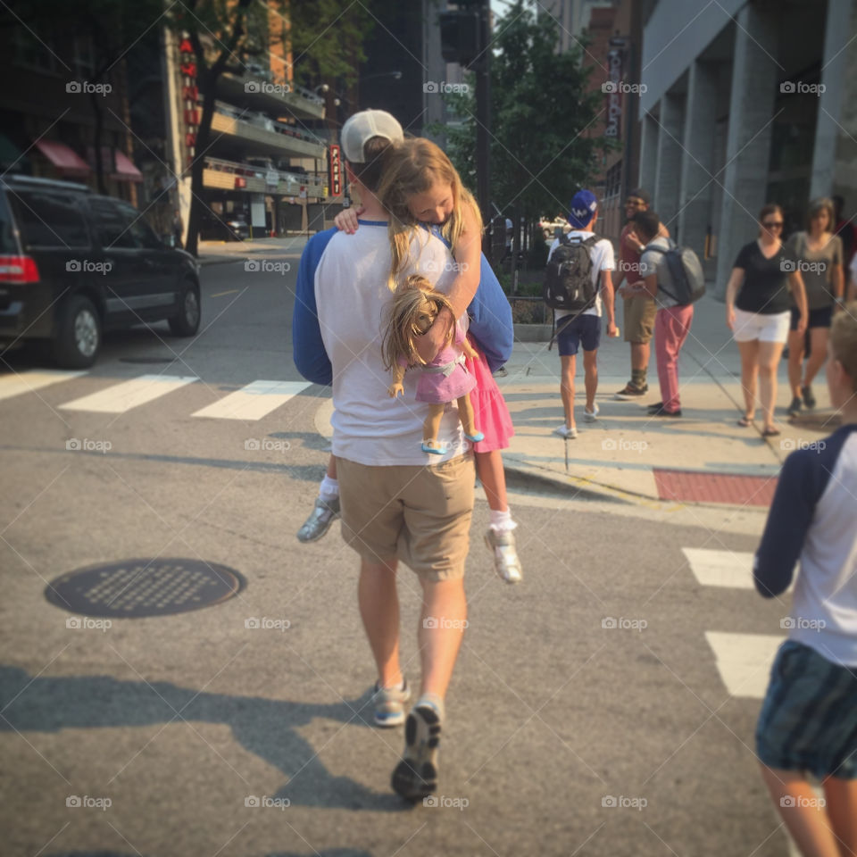 A little girl and her doll in the big city