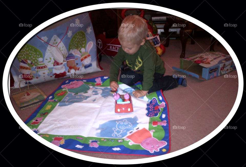 Serious concentration by young boy on painting