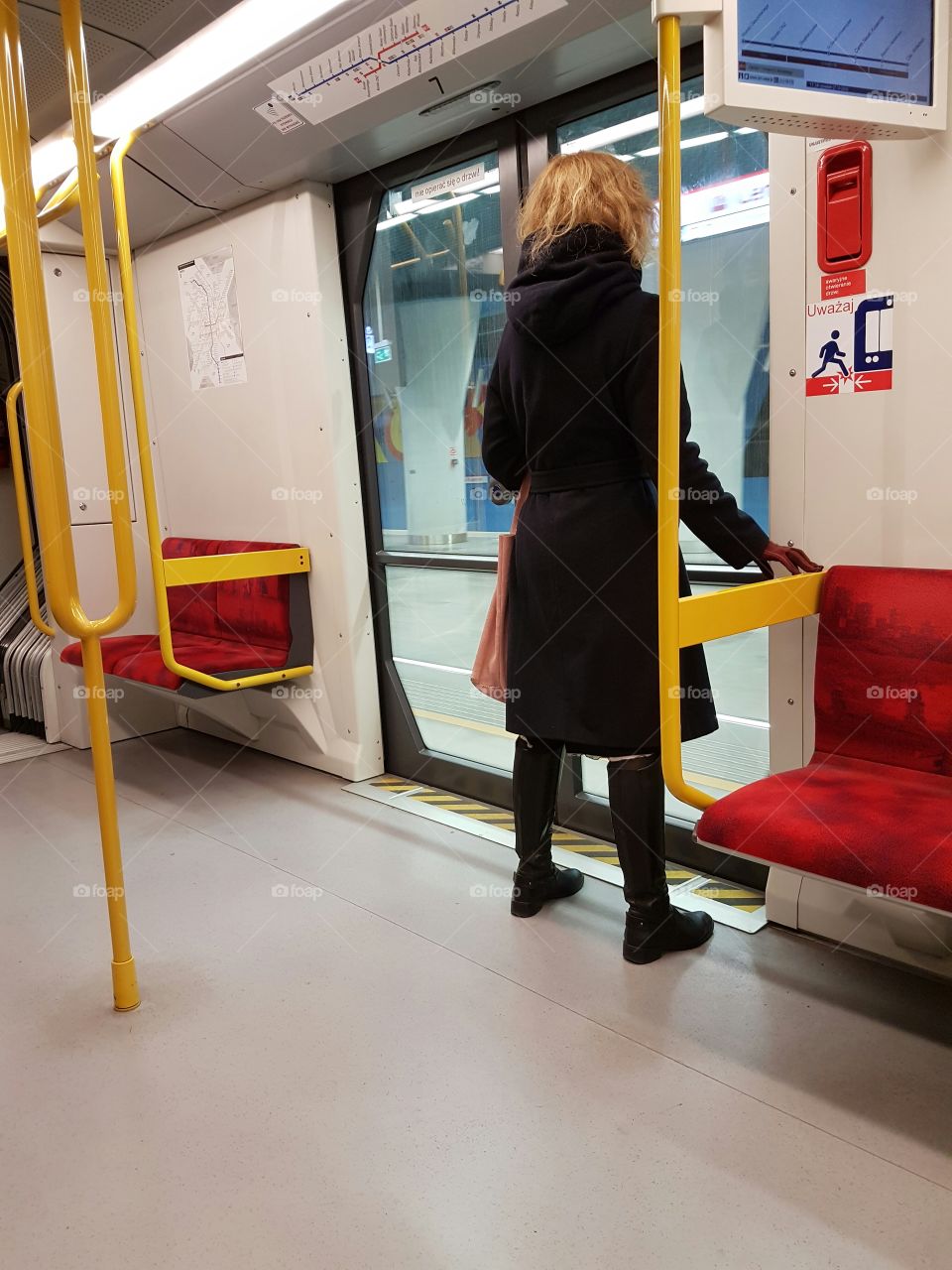 Woman exiting the subway train in Warsaw.