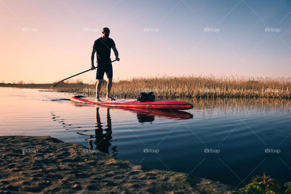 Peddle boarding at sunset