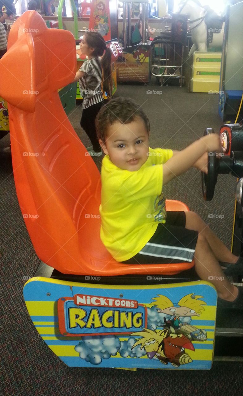 boy playing at arcade. fun outing at Chuck E Cheese
